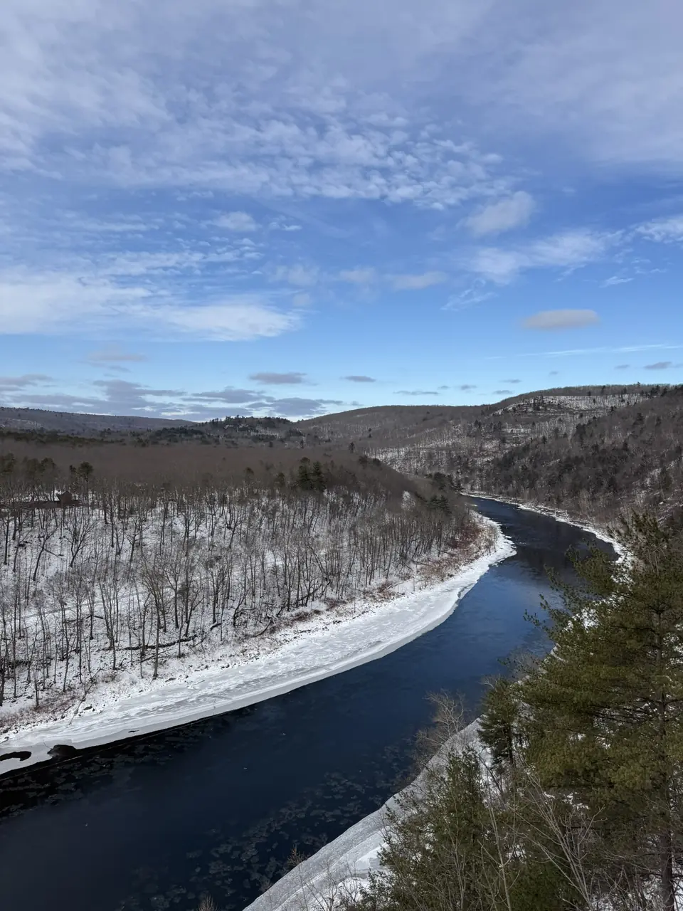 The Delaware River bending through snowy hills