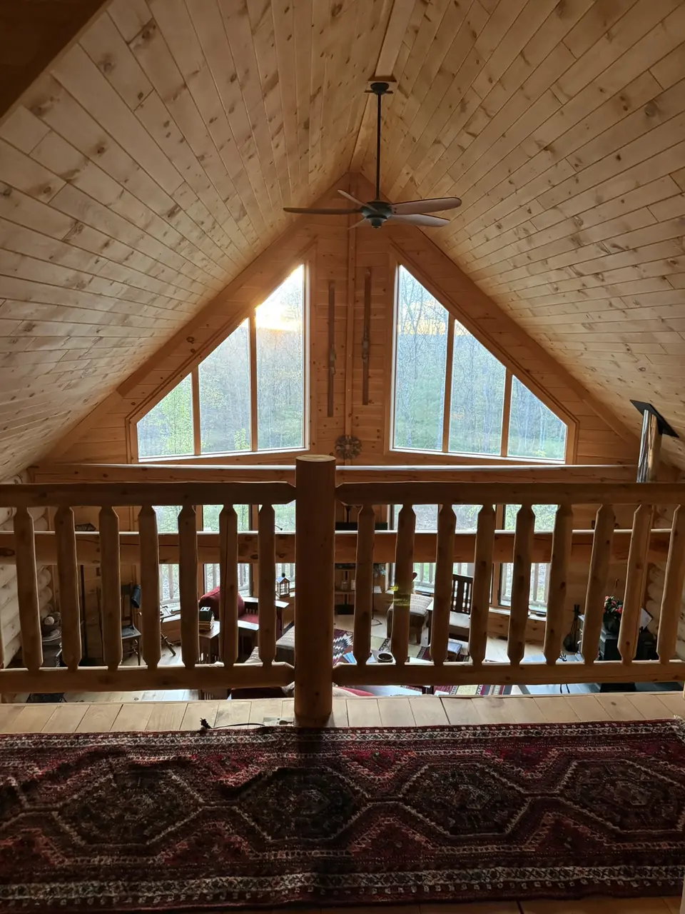 Loft railing beneath the tall peaked window
